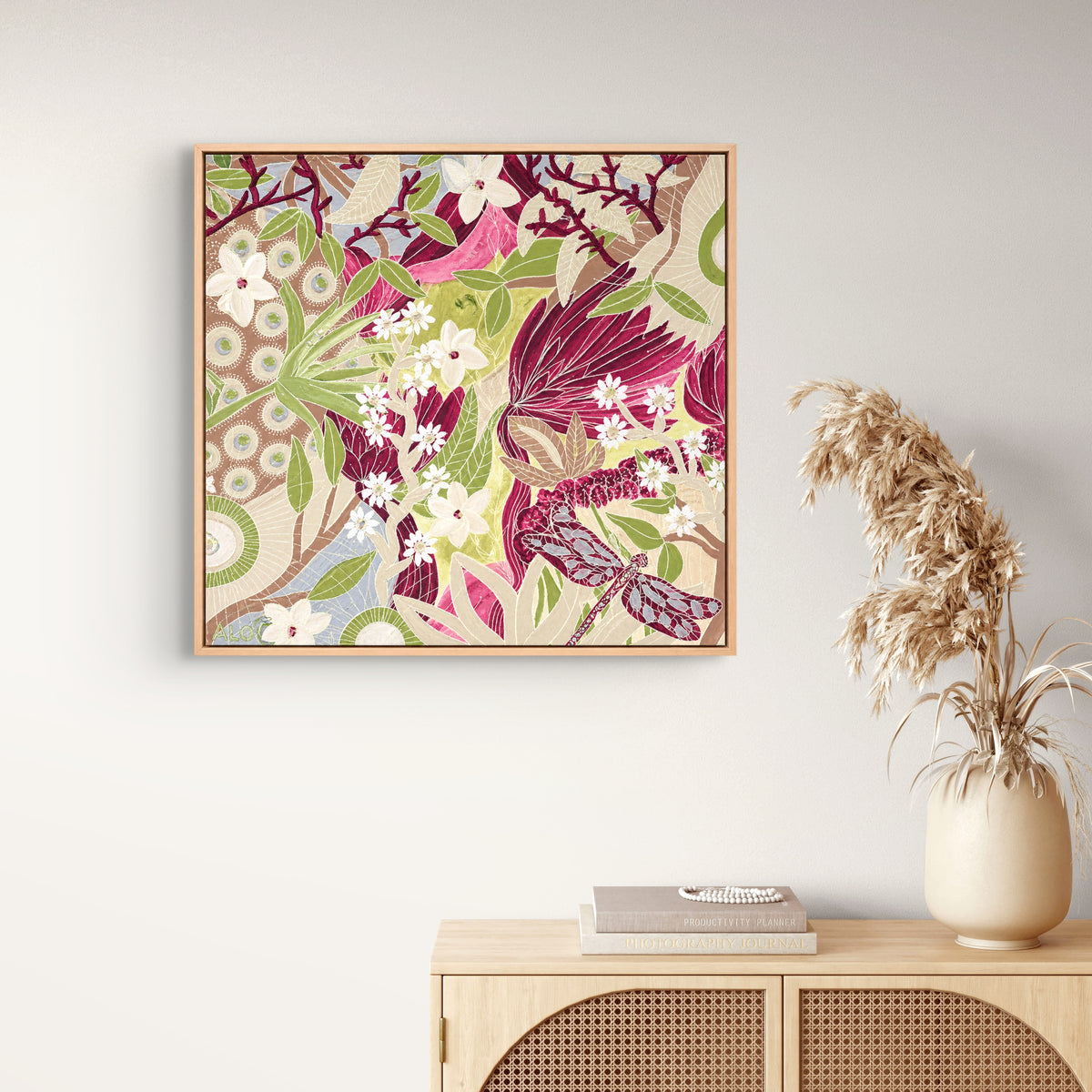 Dance of the Dragonfly 1 by Anna Lohe – framed square artwork above a timber console with a vase of dried grasses