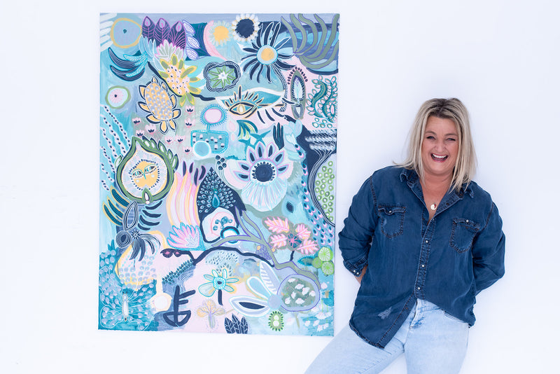 Anna Lohe standing next to Original Australian Artwork called Numero Uno in blue colour palette
