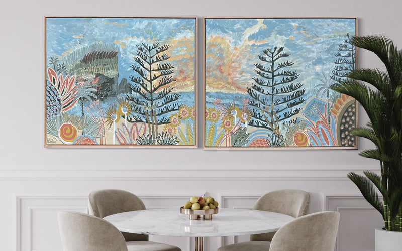 Pair of paintings called Avalonia sunrise displayed on wall next to dining table