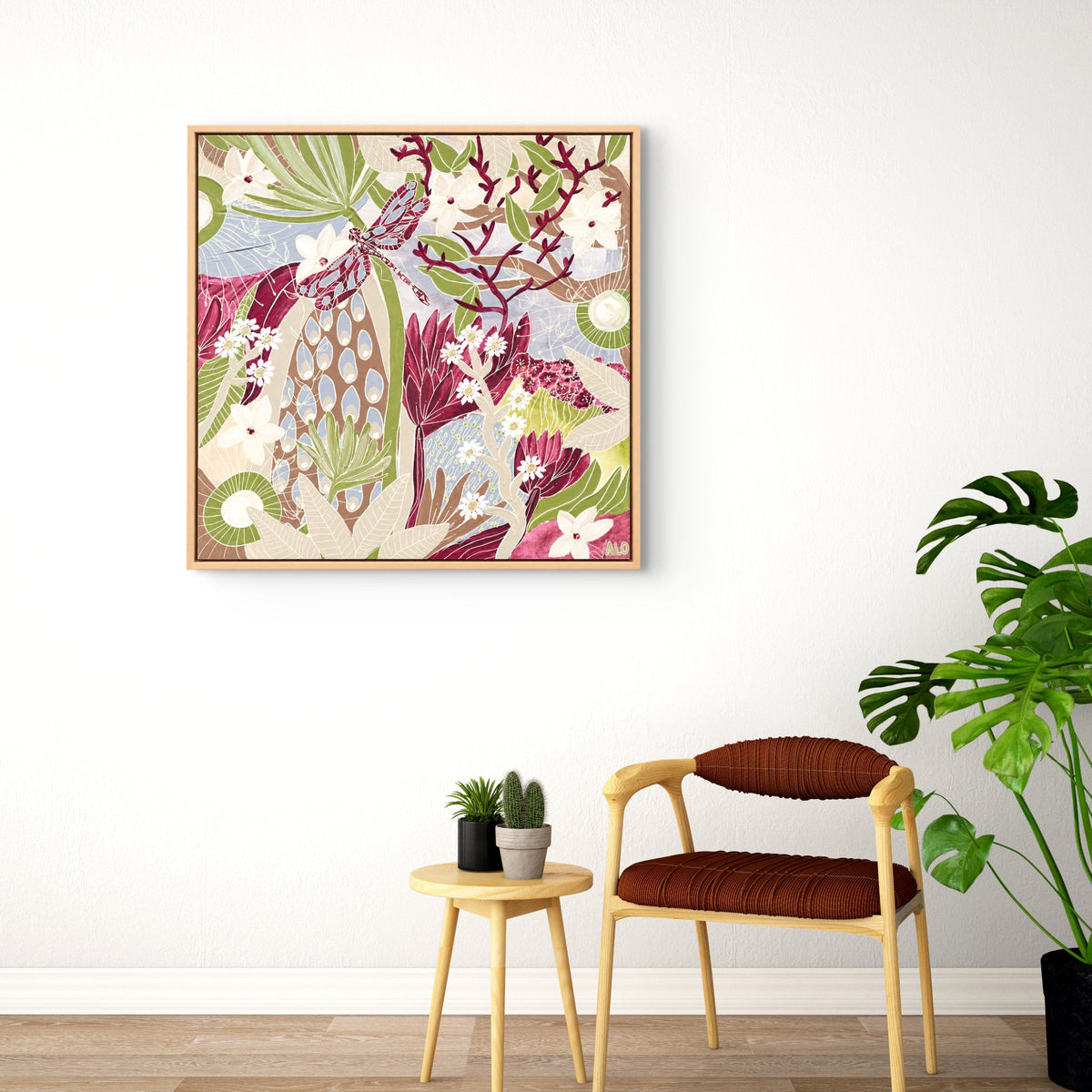 Dance of the Dragonfly 2 by Anna Lohe – framed square artwork above a red chair and small side table