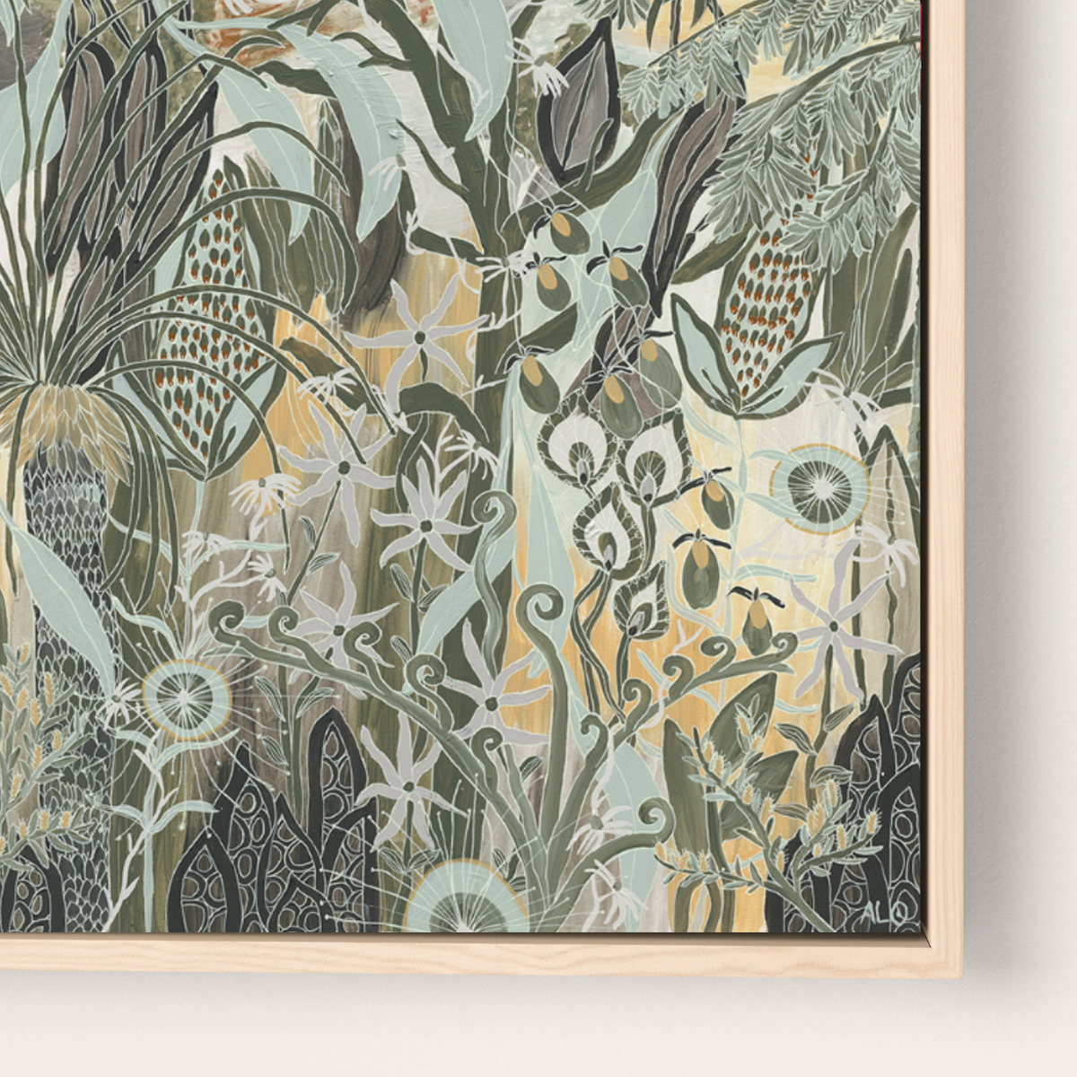 A framed botanical art print featuring an intricate pattern of stylized plants and flowers in muted green, sage, cream, and mustard tones, housed in a light natural wood frame against a clean white wall.