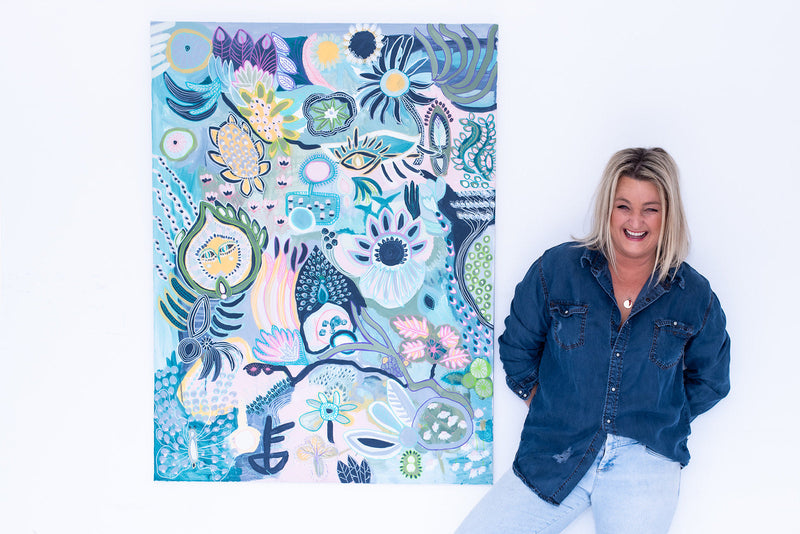 Anna Lohe standing next to original Australian artwork called Numero Uno in light blue colour palette 