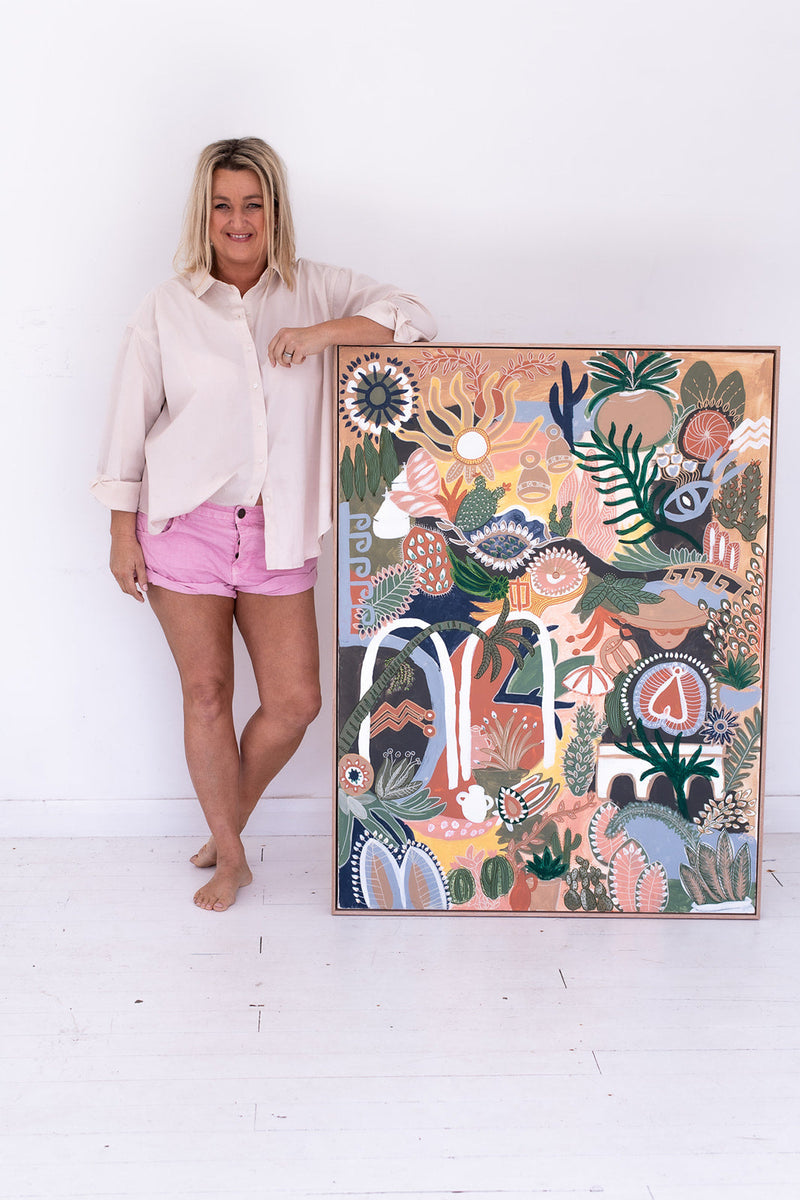 Anna Lohe standing next to original Australian Artwork called Puglia Viva in terracotta colour palette